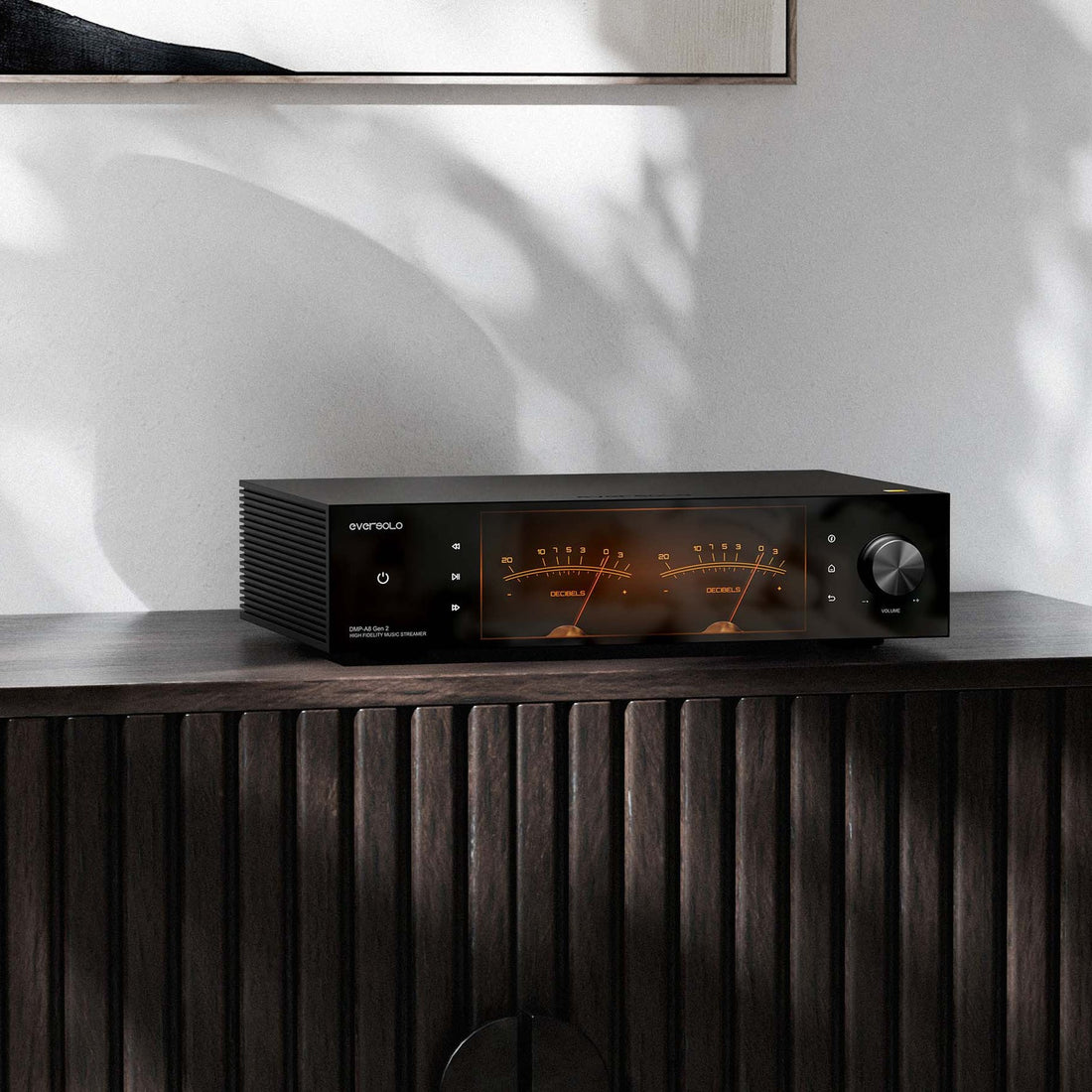 Eversolo DMP-A8 Gen 2 on a dark wood sideboard with the VU meter display lit