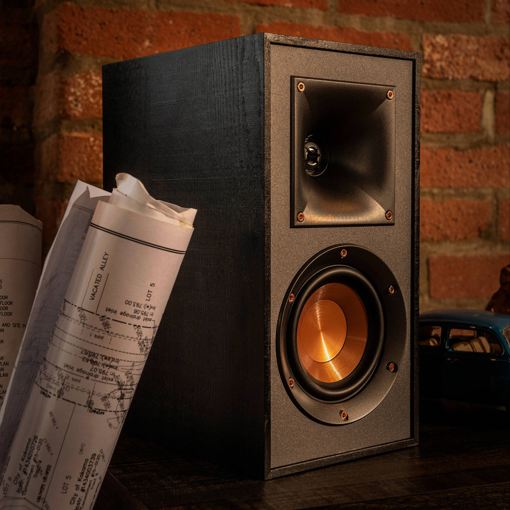 Klipsch R-51PM active bookshelf speakers with black finish and front-facing controls, designed for high-quality audio playback.