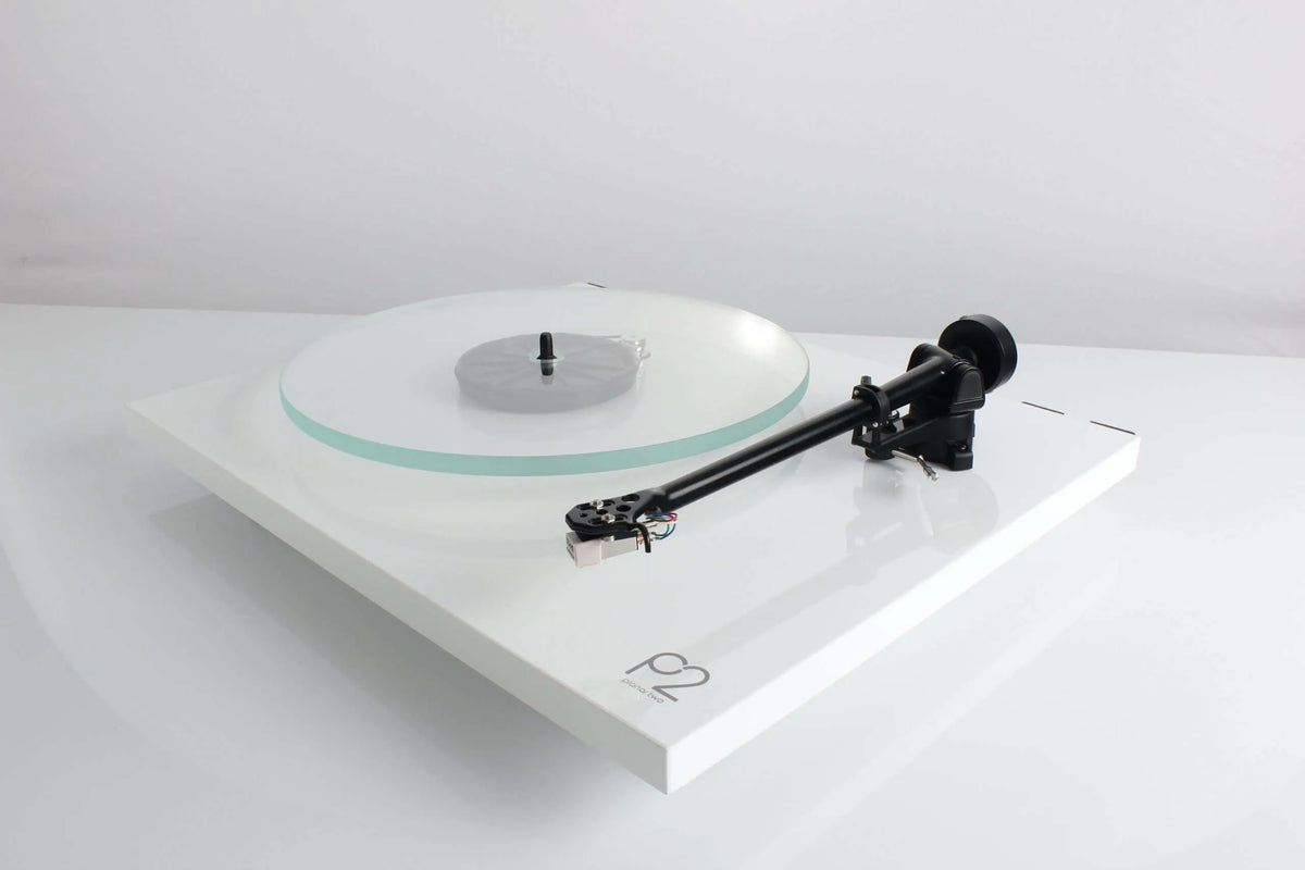 Rega Planar 2 turntable with Nd3 cartridge, showcasing its sleek design and tonearm on a wooden surface.