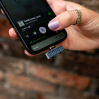 iFi Audio UP Play plugged into a smartphone held in hand
