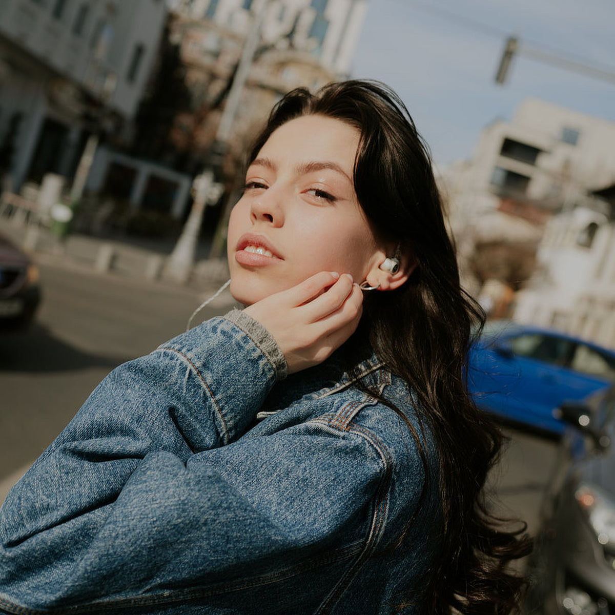 Woman wearing the Meze Audio Alba S in-ear monitors outdoors