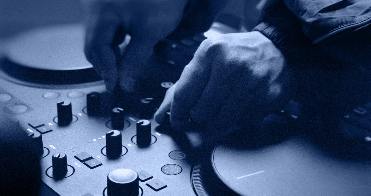 Native Instruments Traktor MX2 DJ controller with jog wheels, faders, and controls for professional DJ mixing.