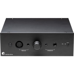 Pro-Ject Head Box DS3 B headphone amplifier and DAC with sleek black design and control knobs, set on a wooden surface.